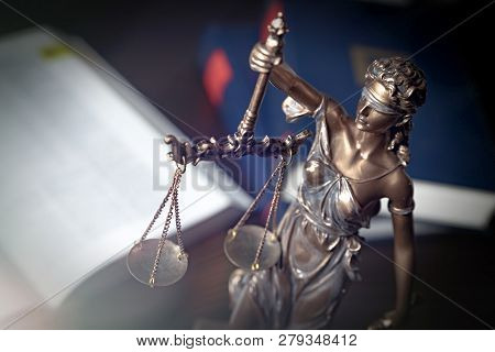 Statue Of Justice On Books Background