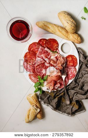 Antipasto Meat Platter Assorti Of Sliced Jamon, Salami, Chorizo Sausage On White Ceramic Board With 