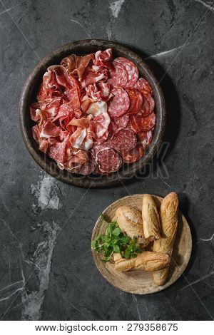 Antipasto Meat Platter Assorti Of Sliced Jamon, Salami, Chorizo Sausage In Terracotta Tray With Brea