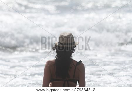 Beautiful Girl, Seen From Behind, With Hat Who Look The Sea. Sea In The Background. Sabaudia, Lazio,