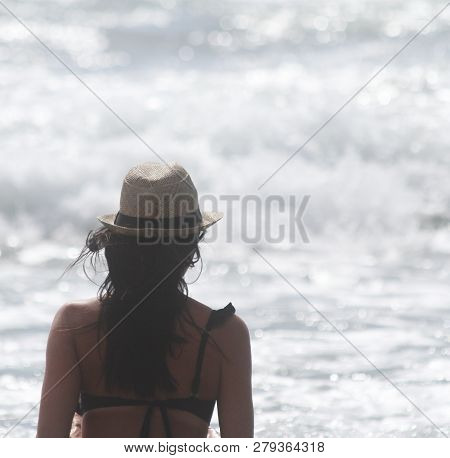 Beautiful Girl, Seen From Behind, With Hat Who Look The Sea. Sea In The Background. Sabaudia, Lazio,