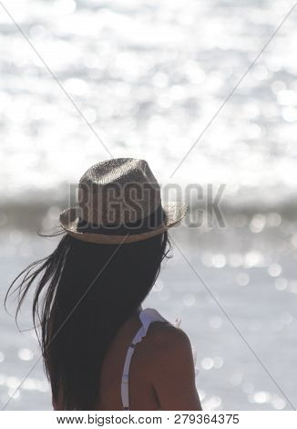 Beautiful Girl, Seen From Behind, With Hat Who Look The Sea. Sea In The Background. Sabaudia, Lazio,