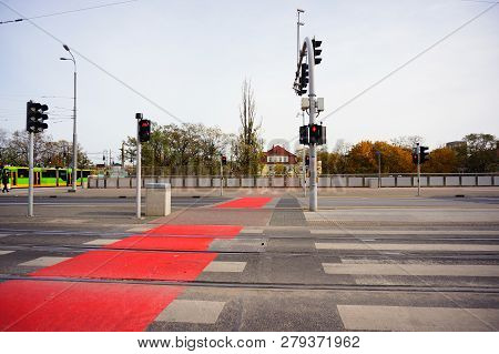Poznan, Poland - November 1, 2018: Zebra Crossing With Red Marked Bicycle Path And Red Lights On The