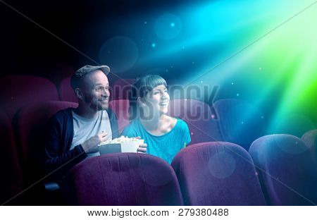 Teenager couple cuddling and watching the climax part of the movie