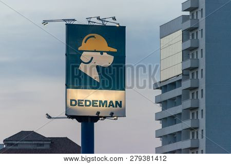 Sibiu, Romania - March 5, 2018: The Dedeman Sign Towards Some Buildings In Sibiu, Romania.