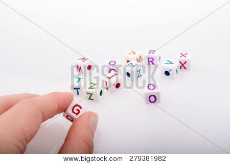 Colorful Alphabet Letter Cubes In Handon A White Background