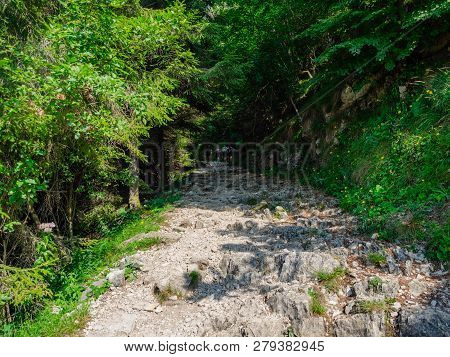 Hikers On Road Of 52 Tunnels On The Pasubio Massif In Veneto, Italy.