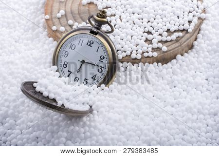 Retro Pocket Watch On White Polystyrene Balls