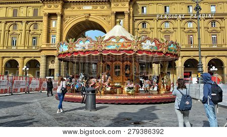 Tourists Relax At The Republic Square In Florence. Arcone Triumphal Arch. Beautiful Carousel. Landma