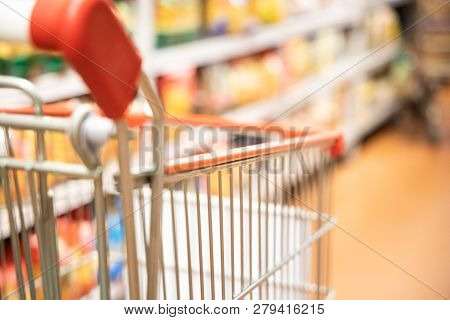 Shopping Trolley Cart With Shallow Dof Against Supermarket Aisle Background