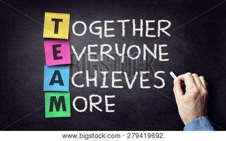Team - together everyone achieves more written on blackboard
