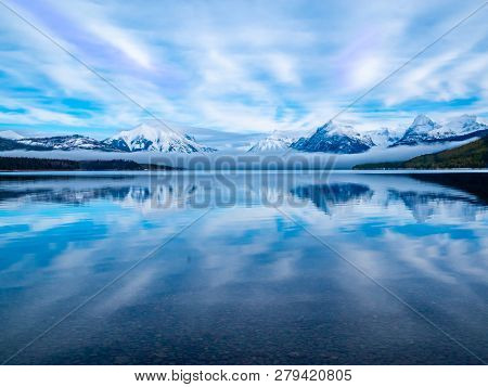 With Low Lying Clouds And The Magnificient Snow Covered Mountains Pushing Up Through The Clouds, The