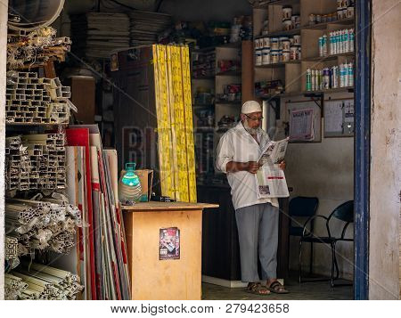 A Muslim Shop Keeper With Traditional Cap