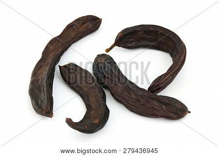 Carob On White Ground, Dry Carob
Locust Bean On A White Background,
Carob On A Plate, On A White Bac