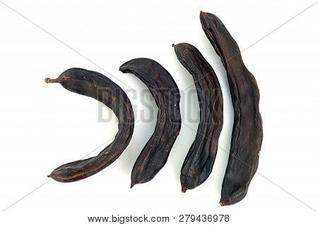 Carob On White Ground, Dry Carob
Locust Bean On A White Background,
Carob On A Plate, On A White Bac