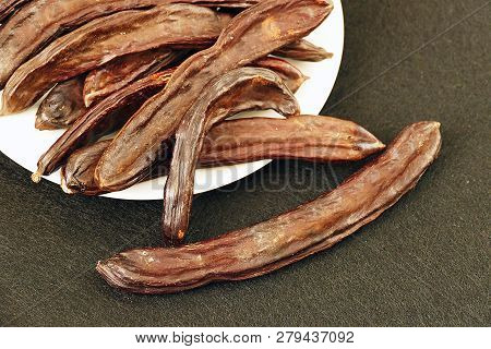 Carob On White Ground, Dry Carob
Locust Bean On A White Background,
Carob On A Plate, On A White Bac