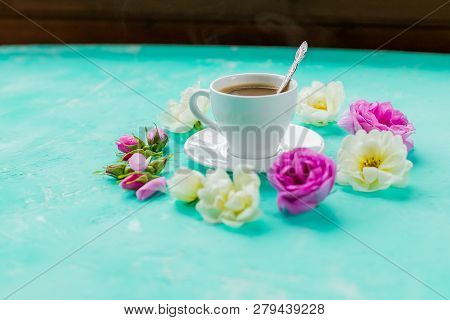 Colorful Flowers And Morning Cup Of Coffee On Blue Background. The Concept Of Hot Drink, Coffee For 