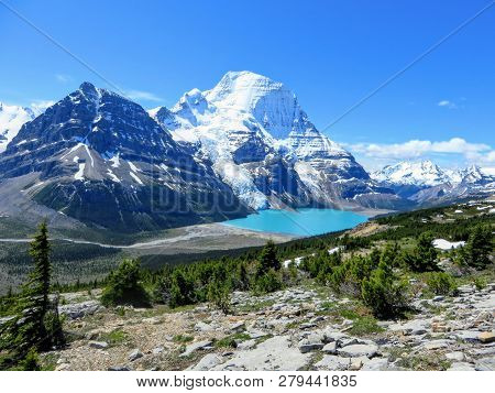 An Incredible View Of A Beautiful Turquoise Lake At The Base Of Two Huge Mountains And A Glacier In 