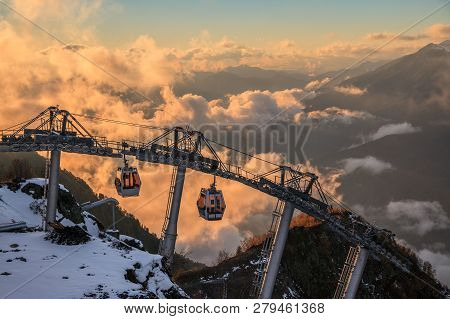 Cable Car Ski Lifts In Gorky Gorod Mountain Ski Resort Can. Beautiful Scenic Sunset Landscape. Sochi