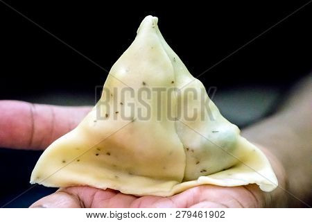 A Male Put A Samosa In Their Hand
