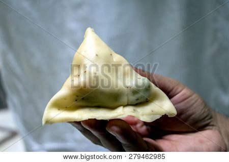 A Male Put A Samosa In Their Hand