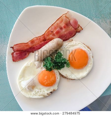 American Breakfast. Delicious Breakfast For One. Woman Hands Cutting Knife Egg In A Frying Pan. View