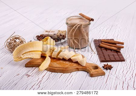 Detox Coctail With Cinnamon Sticks, Bananas And Chocolate Lie On The Table
