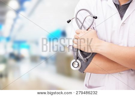 Doctor With A Stethoscope In The Hands And Hospital Background.