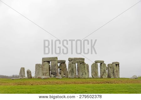 Amesbury, Great Britain - Dec 23, 2018: The Stone Monument Stonehenge A Cloudy Day, Built In The Lat