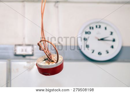 Closeup Clock And Installation And Repair Of Electric Cable, Smoke Detector, Fire Alarm System Befor