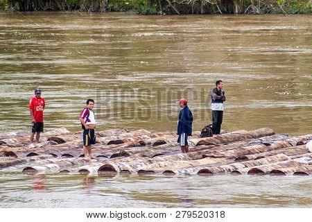Napo, Peru - July 16, 2015: Local People Transport Logs On River Napo
