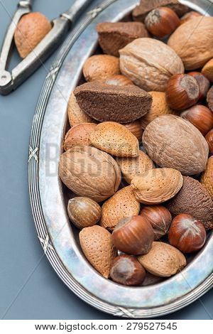 Different Kinds Of Nuts In The Shell: Hazelnut, Walnut, Almond And Brazil Nuts On The Plate With Nut