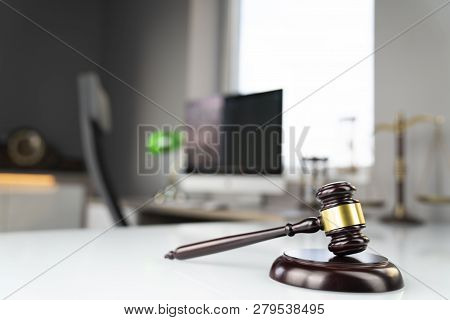 Lawyers Office. Gavel And Computer On The White Table.