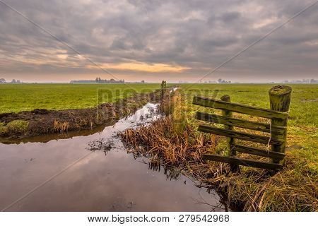 Polder Landscape On Cloudy Winter Day In Friesland, The Netherlands