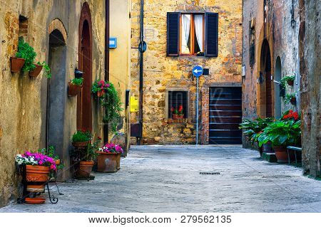Amazing Travel Destination In Tuscany, Rustic Traditional Decorated Street With Colorful Flowers And