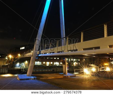 Detail Of The Pedestrian Footbridge Crossing The River Aire In Leeds At Night With Bright Lights And
