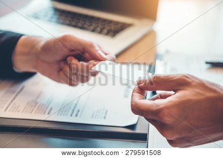 Employee Young Man Exchanging A Business Card To Senior Manager During Job Interview Concept