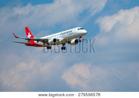 Zurich, Switzerland - July 19, 2018: Helvetic Swiss airlines airplane preparing for landing at day time in international airport