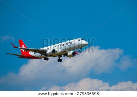 Zurich, Switzerland - July 19, 2018: Helvetic Swiss airlines airplane preparing for landing at day time in international airport