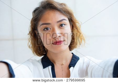 Self Portrait Of Beautiful Chinese Girl Walking Outdoors. Closeup Of Young Attractive Woman Looking 