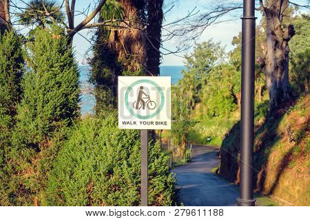 Walk Your Bike Sign In The Garden