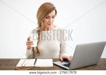 Good Looking Retired Mature Woman Blogger Enoying Modern Electronic Devices And Online Communication