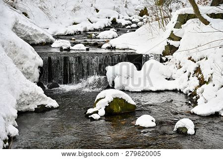 Winter Stream With Stones And Snow. A Beautiful Winter Concept For Winter And Frost.