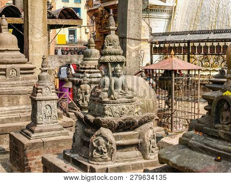 Fragment Of The Swayambhunath Temple Complex With Some Stone Statues Close-up, Kathmandu, Nepal