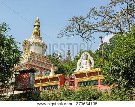 Small Stupa And Buddha Statue At The Southeastern Foot Of The Swayambu Hill On A Background Of Swaya