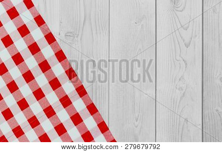 White Vintage Wooden Table With Red Checker Napkin. Checkered Fabric And Wooden Light Background. De
