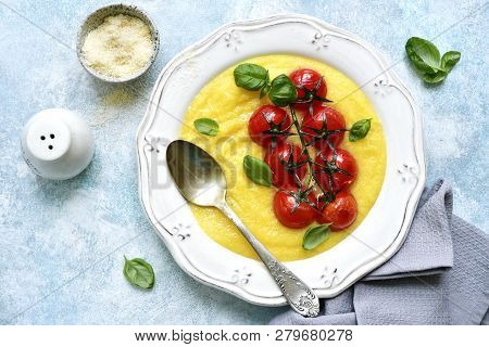 Traditional Italian Dish Polenta With Parmesan Cheese And Grilled Tomato.