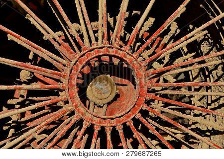 Mud Is Caked In The Spokes Of A Massive Steam Engine Wheel