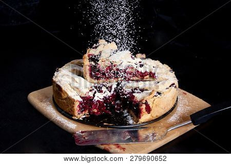 Baked American сherry Pie With Powdered Sugar In The Kitchen At Home