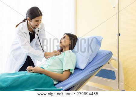 Asian Doctor make routine health check with patient in hospital ward